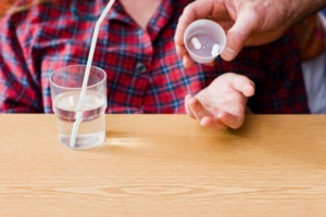patient with pills and water 